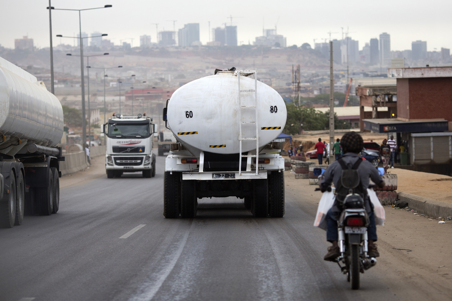 Oil tankers pass along the road towards the capital Luanda, Angola.