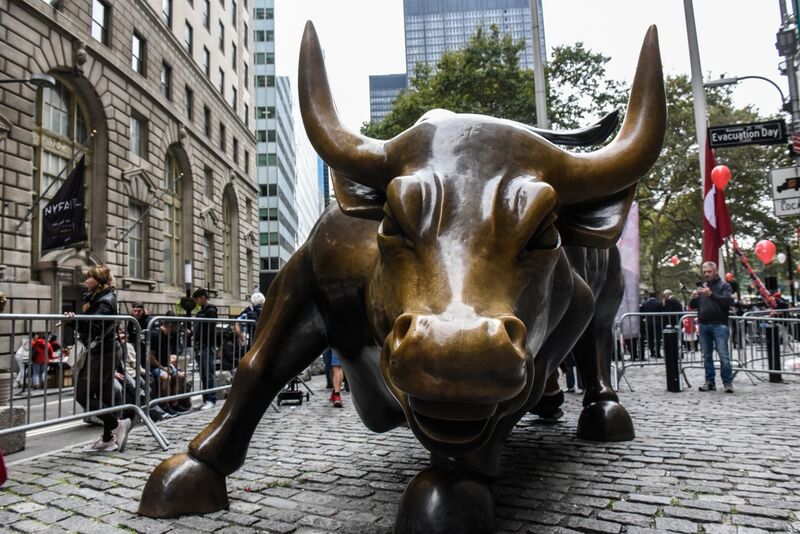 Visitors at the "Charging Bull" statue near the New York Stock Exchange.