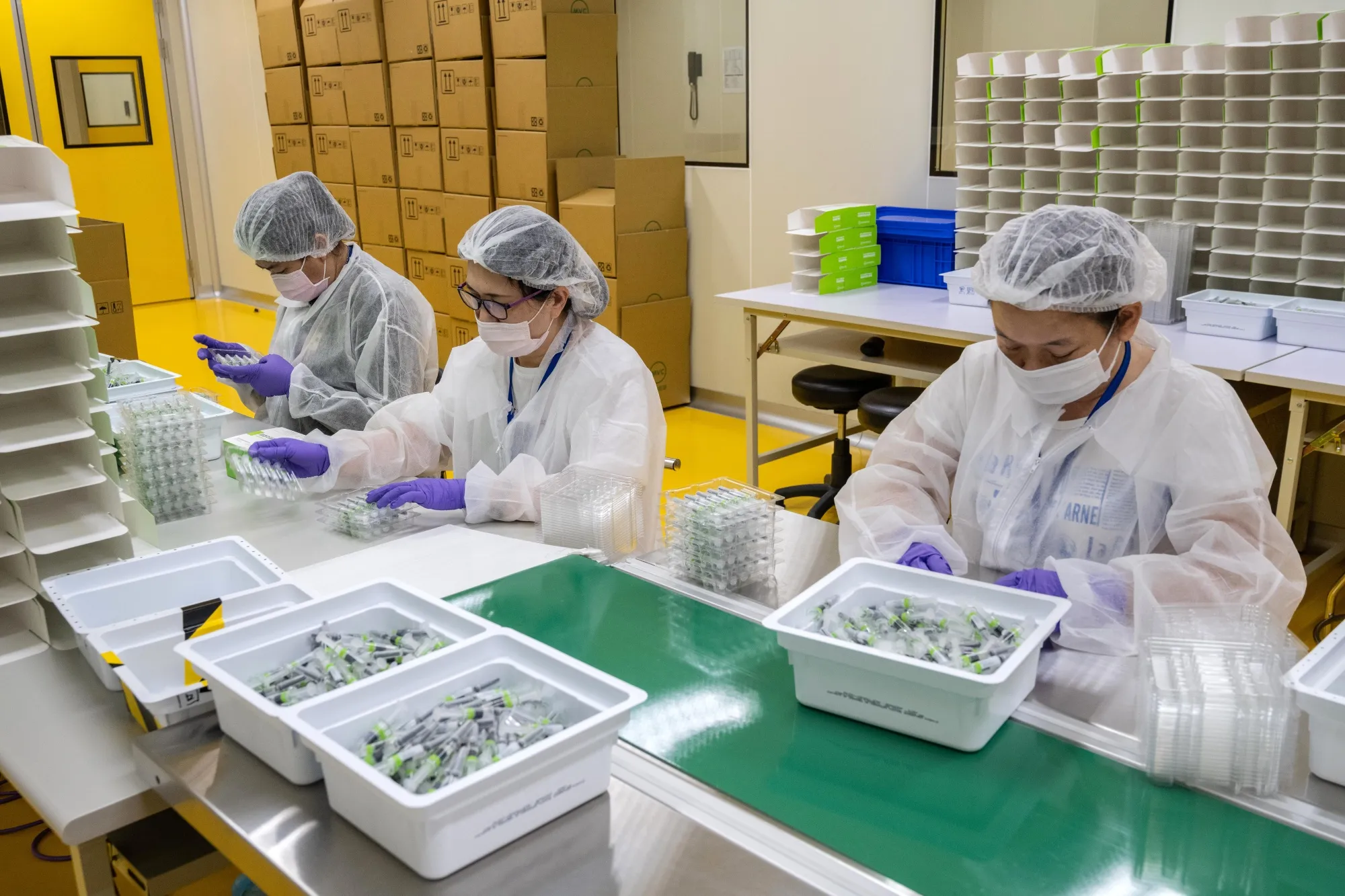 Workers on the Medigen Vaccine Biologics Corp. (MVC) COVID-19 vaccine packaging line,&nbsp;in Hsinchu, Taiwan.