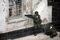 NALCHIK, RUSSIAN FEDERATION: A member of Russian special armed forces storms a shop, as his colleague lies wounded next to him in the southern city of Nalchik, 14 October 2005, where gunmen were holed-out following a deadly rampage the previous day. Russian security forces Friday stormed a police station and a shop where gunmen were holed up following a deadly rampage in the southern city of Nalchik, killing 10 rebels and freeing at least five hostages, officials said. AFP PHOTO / MAXIM MARMUR (Photo credit should read MAXIM MARMUR/AFP/Getty Images)
