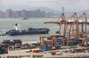 A container ship passes in front of containers and gantry cranes at the Haitian Container Terminal, operated by the Xiamen Port Authority, in Xiamen, China, on Monday, Aug. 26, 2019. After a weekend of confusing signals, only a few negotiators in Beijing see a deal possible ahead of the 2020 U.S. election, in part because it’s dangerous to advise President Xi Jinping to sign a deal that Trump may eventually break, according to Chinese officials familiar with the talks who asked not to be identified.