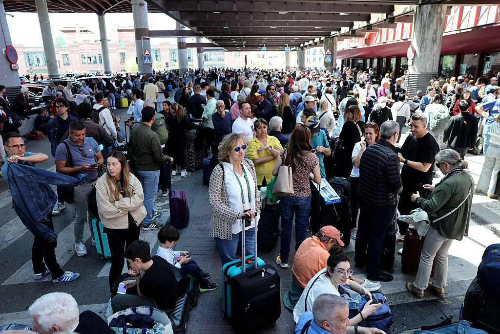 People wait outside the Atocha train station in Madrid after its closure as a massive power outage hit&nbsp;Spain on April 28.