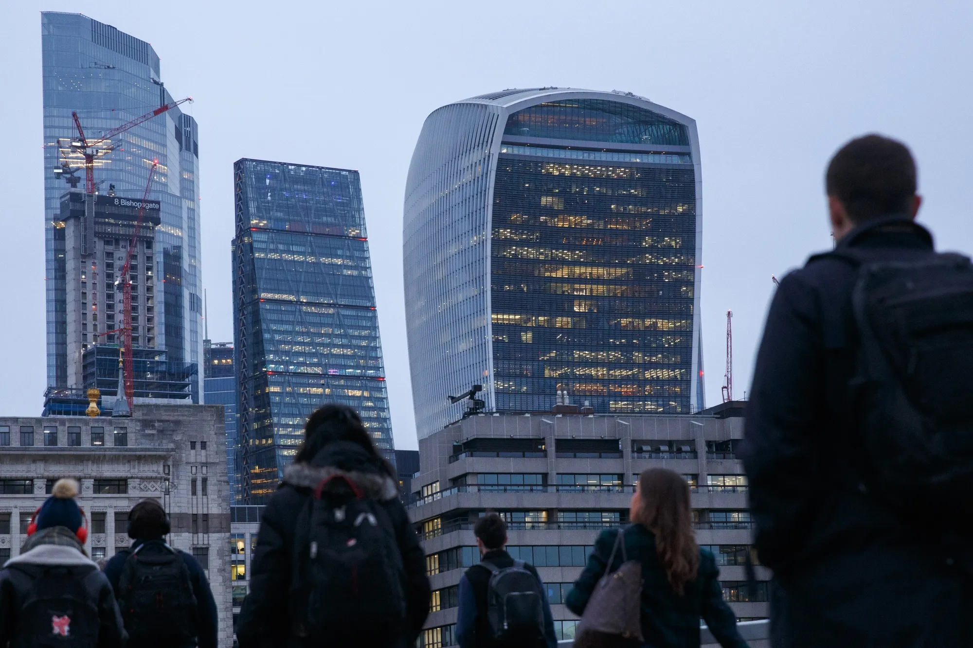 Morning commuters cross London Bridge towards the City of London.