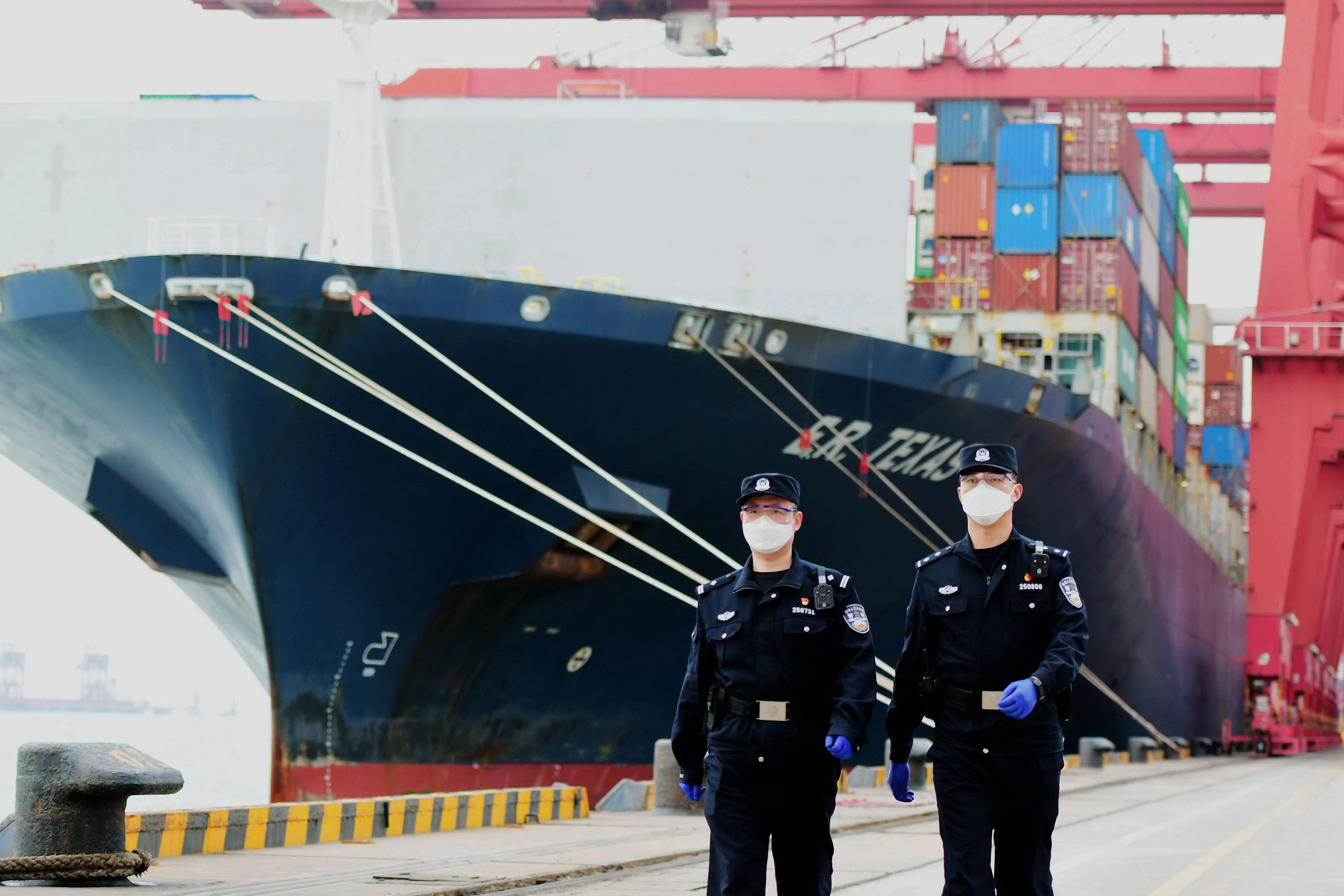 Police patrol a foreign trade container terminal at the port of Qingdao in Shandong Province, China, on March 13.