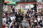 Crowds outside Ezell’s Chicken in Seattle’s Central District neighborhood listen to march organizers explain gentrification issues in this historically black neighborhood during the Juneteenth Freedom March and Celebration on June 19.