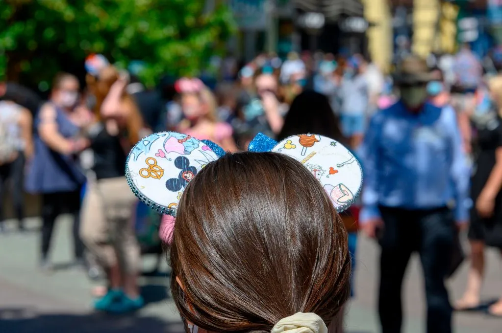 People visit Downtown Disney in Anaheim, California on July 9, 2020, the first day the outdoor shopping and dining complex has been open to the public since it closed in mid-March amid the COVID-19 pandemic. - Disney's California theme park reopening may have been thwarted by coronavirus, but hundreds lined up early July 9, 2020 to buy Mickey Mouse merchandise from an adjacent shopping plaza. Downtown Disney District -- which borders the world-famous Disneyland and Disney California Adventure theme parks near Los Angeles -- is the first part of the sprawling resort to reopen. (Photo by Robyn Beck / AFP) (Photo by ROBYN BECK/AFP via Getty Images)