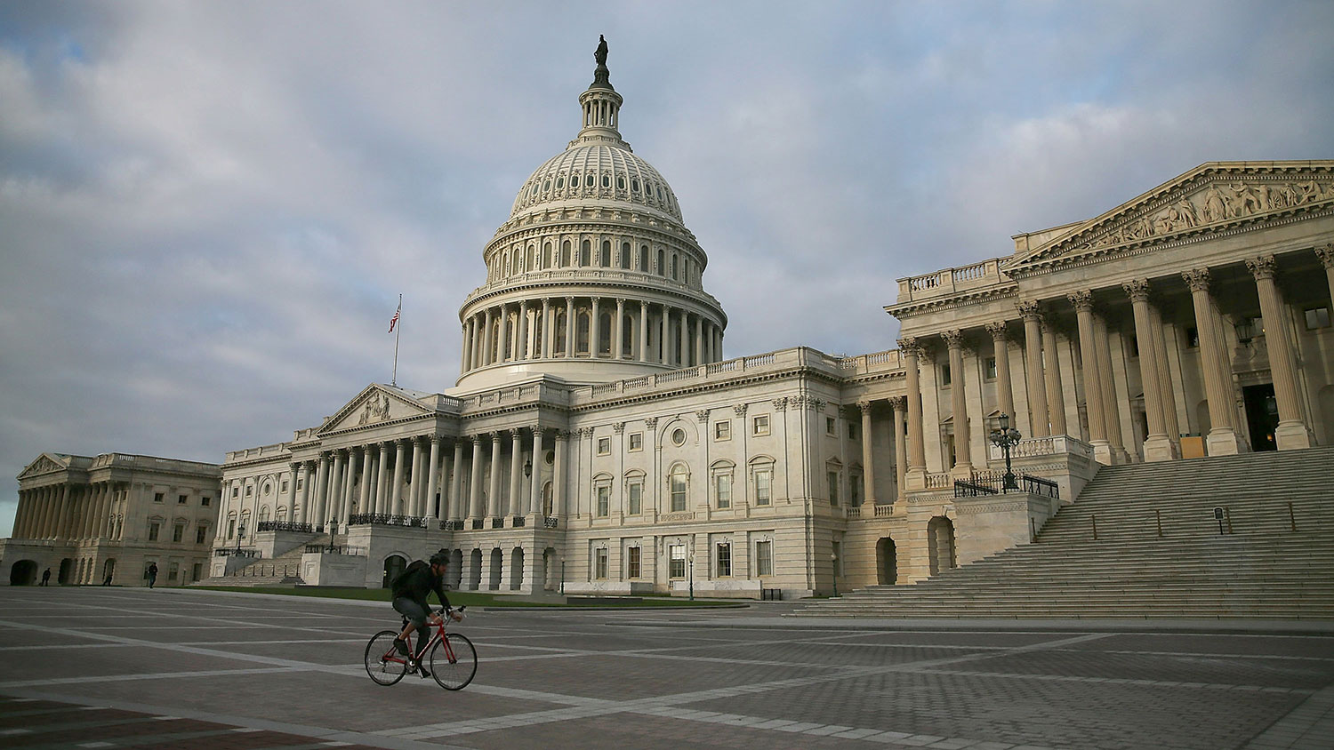 A biker rides past the U.S. Capitol , October 14, 2013 in Washington, DC.
