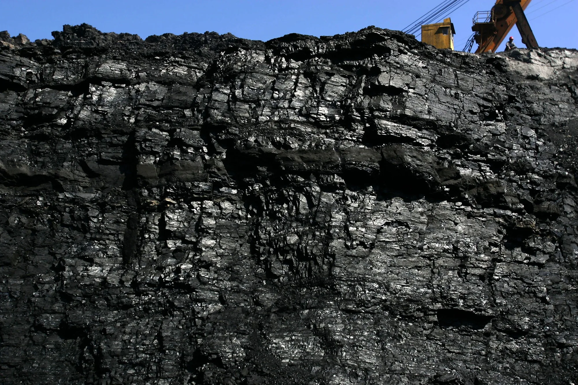 A coal miner works on coal seams in an open pit coal mine on August 19, 2006 in Chifeng of Inner Mongolia Autonomous Region, China.&nbsp;