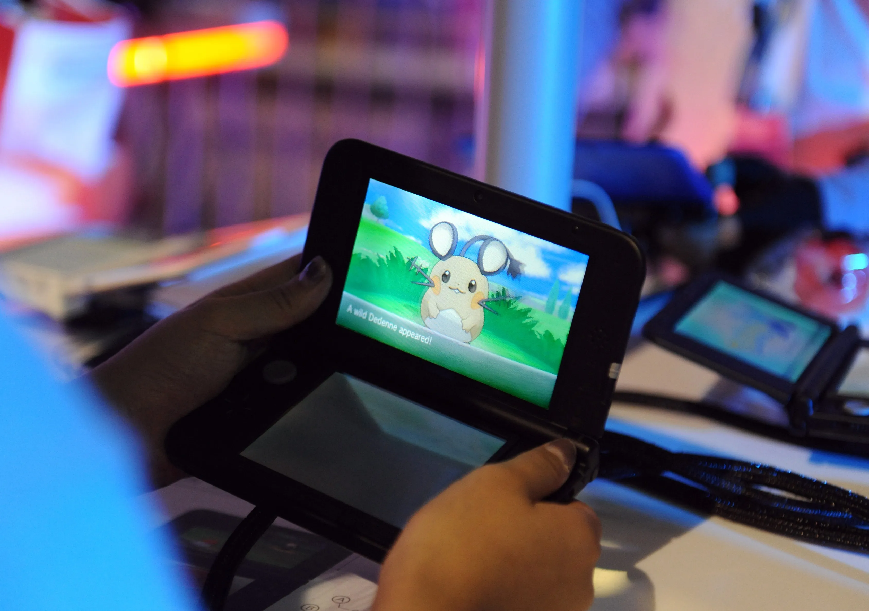 Attendees play the new Pokemon X and Pokemon Y video games on the Nintendo Co. 3DS at a launch event in New York.
