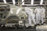 Employees work on Lynk & Co. 05 crossover sport utility vehicles (SUV) in the paint shop at the Geely Automobile plant in Ningbo, Zhejiang Province, China on April 28.