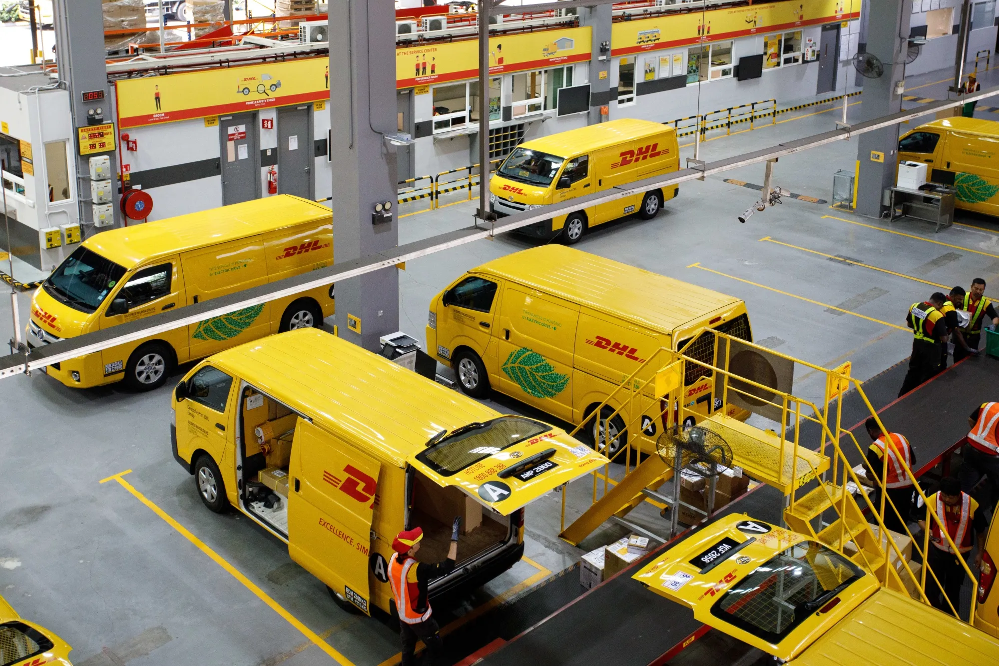Delivery vans at the DHL Express Service Center facility in Malaysia.
