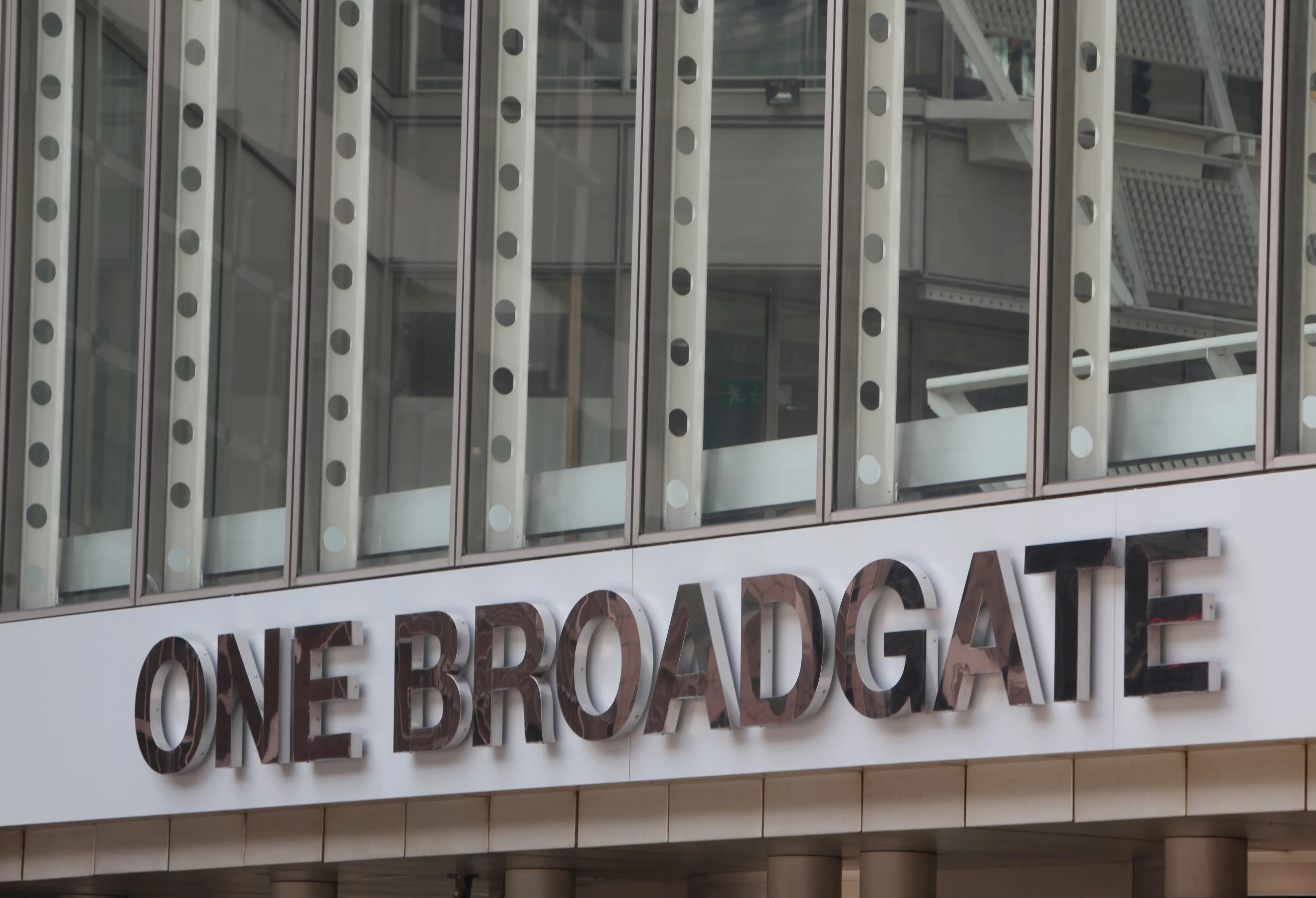 A sign hangs outside an office building at the Broadgate development in London, U.K., on Tuesday, July 6, 2010. British Land Co., which sold half of the Broadgate complex last year, plans to switch the focus of its office business to the entertainment district.