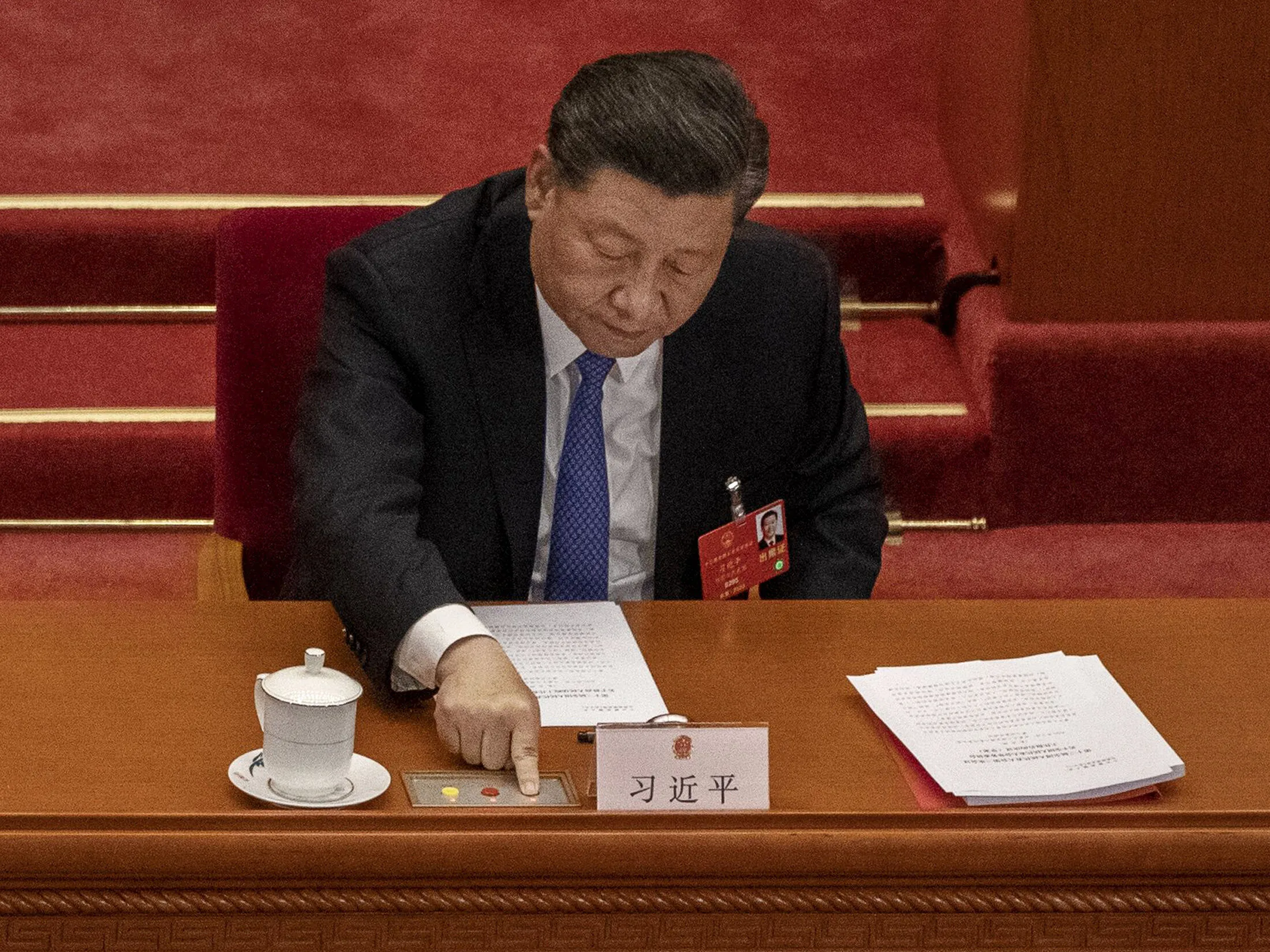 Chinese President Xi Jinping presses the green button as he votes during the closing session of the National People’s Congress at the Great Hall of the People in Beijing on May 28.
