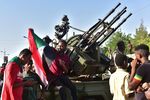 Young Sudanese sit atop a military vehicle as they celebrate the end of Omar al-Bashir’s regime on April 13.