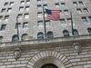 The U.S. flag hangs on the facade of the Federal Reserve Bank of New York headquarters in New York.