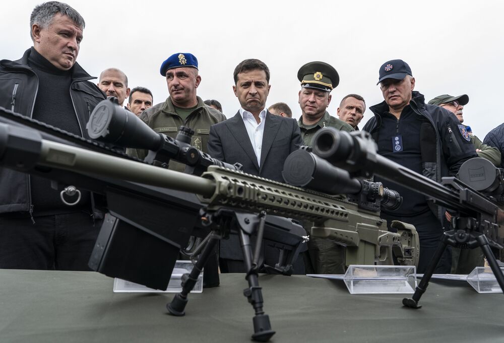 Volodymyr Zelenskiy inspects sniper rifles during a drill in Stare, Ukraine, in 2019.