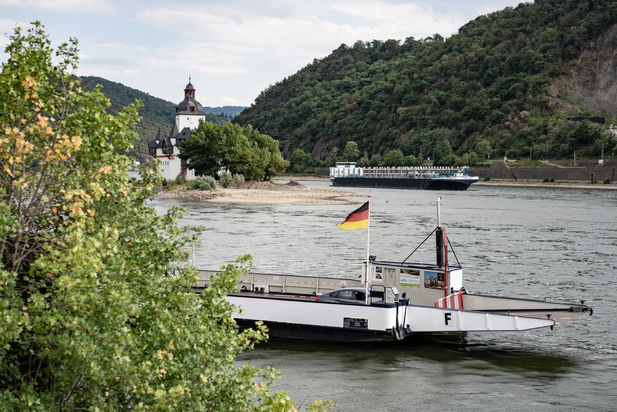 A chemical tanker passes a ferry boat on the River Rhine near Pfalzgrafenstein castle in Kaub, Germany.