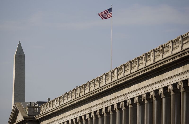 The U.S. Department of the Treasury, with the Washington Monument in the background, stands in Washington, D.C., U.S.