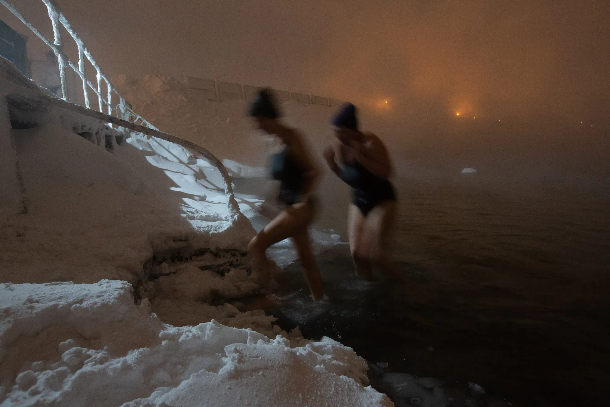 Cold-water swimmers exit the waters of Lake Dolgoye at the Umka ice swimming club in Norilsk, Russia.
