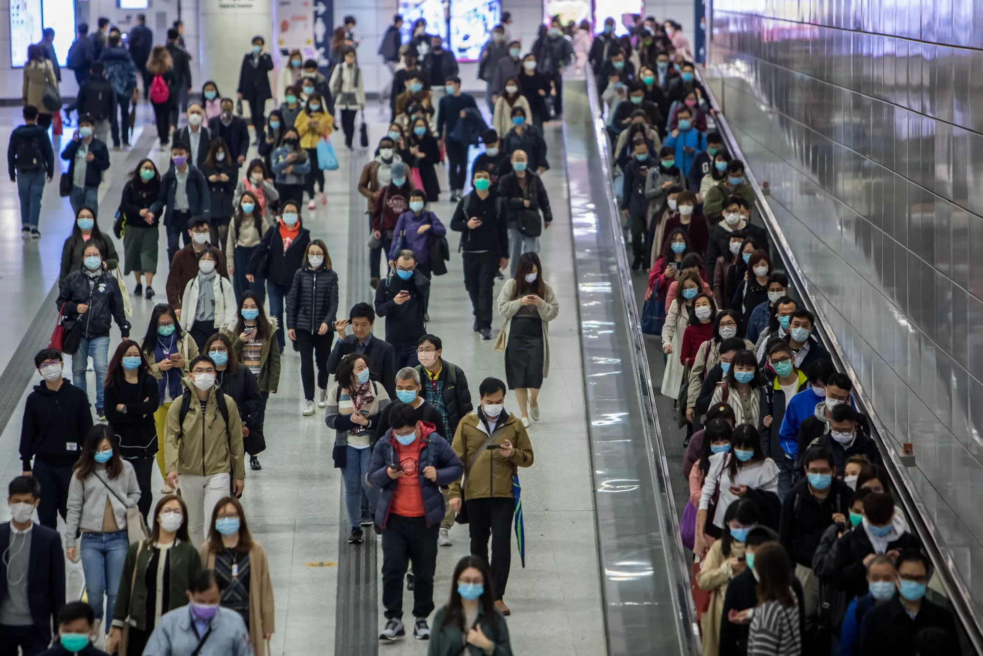 Commuters wearing protective masks walk through Hong Kong Station, in Hong Kong, China.&nbsp;