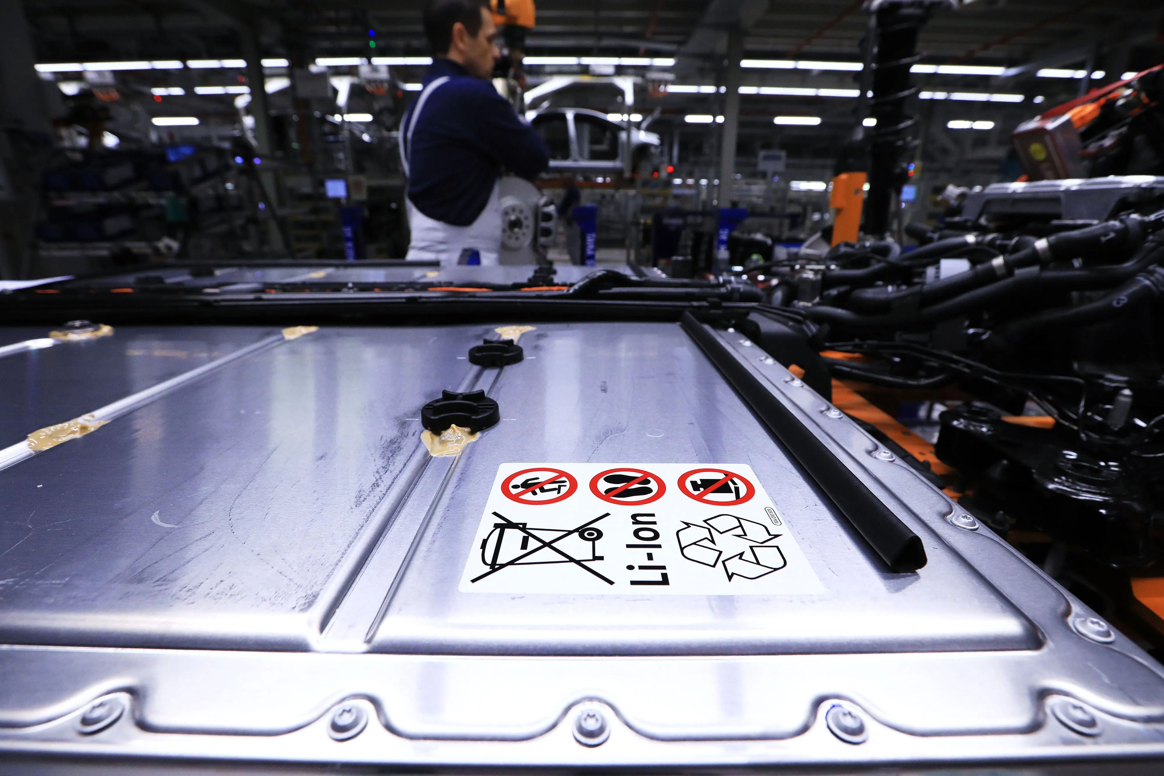 A lithium-ion automotive battery pack sits on the chassis of a Volkswagen ID.3 electric automobile at the automaker's factory in Zwickau, Germany.