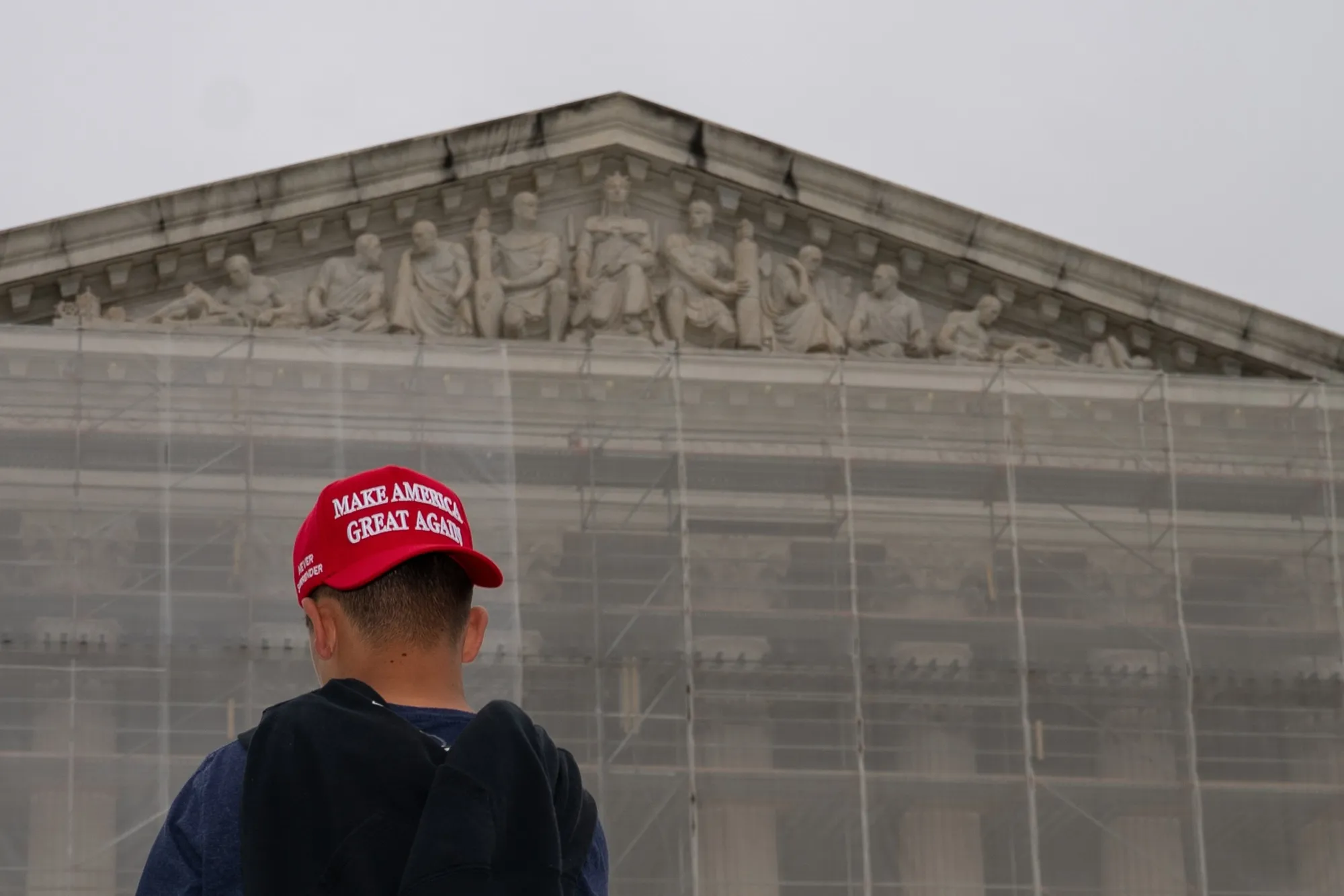 A pedestrian wears a "Make America Great Again" hat outside the US Supreme Court in Washington in June.