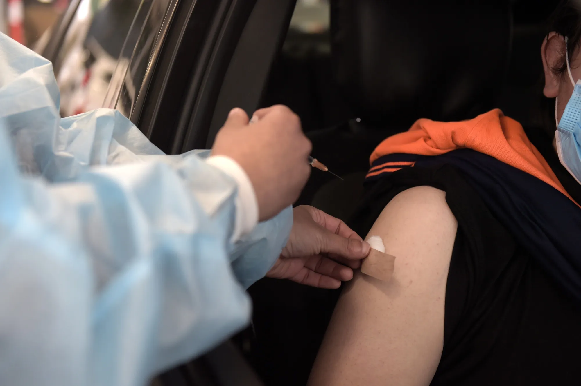 A health worker administers a dose of the Pfizer-BioNTech Covid-19 vaccine at a drive-thru vaccination hub in Melbourne, Australia, on&nbsp;Aug. 9.&nbsp;