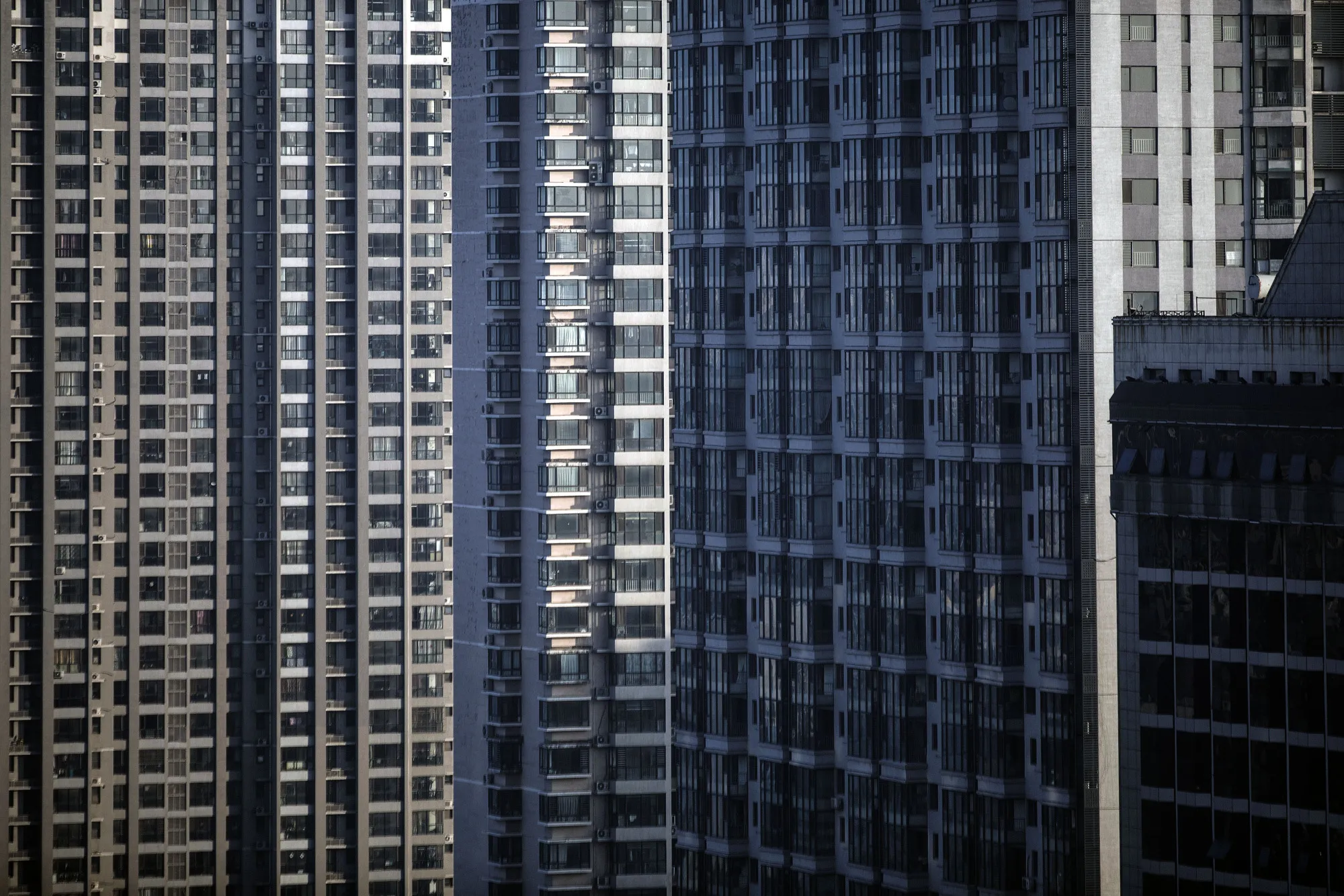 Residential buildings stand in Qinhuangdao, Hebei province, China, on Friday, Oct. 28, 2016. China's top overseas bond fund said Chinese property dollar bonds are still worth holding because the government won't allow a real estate slump even as it seeks to curb a bubble.