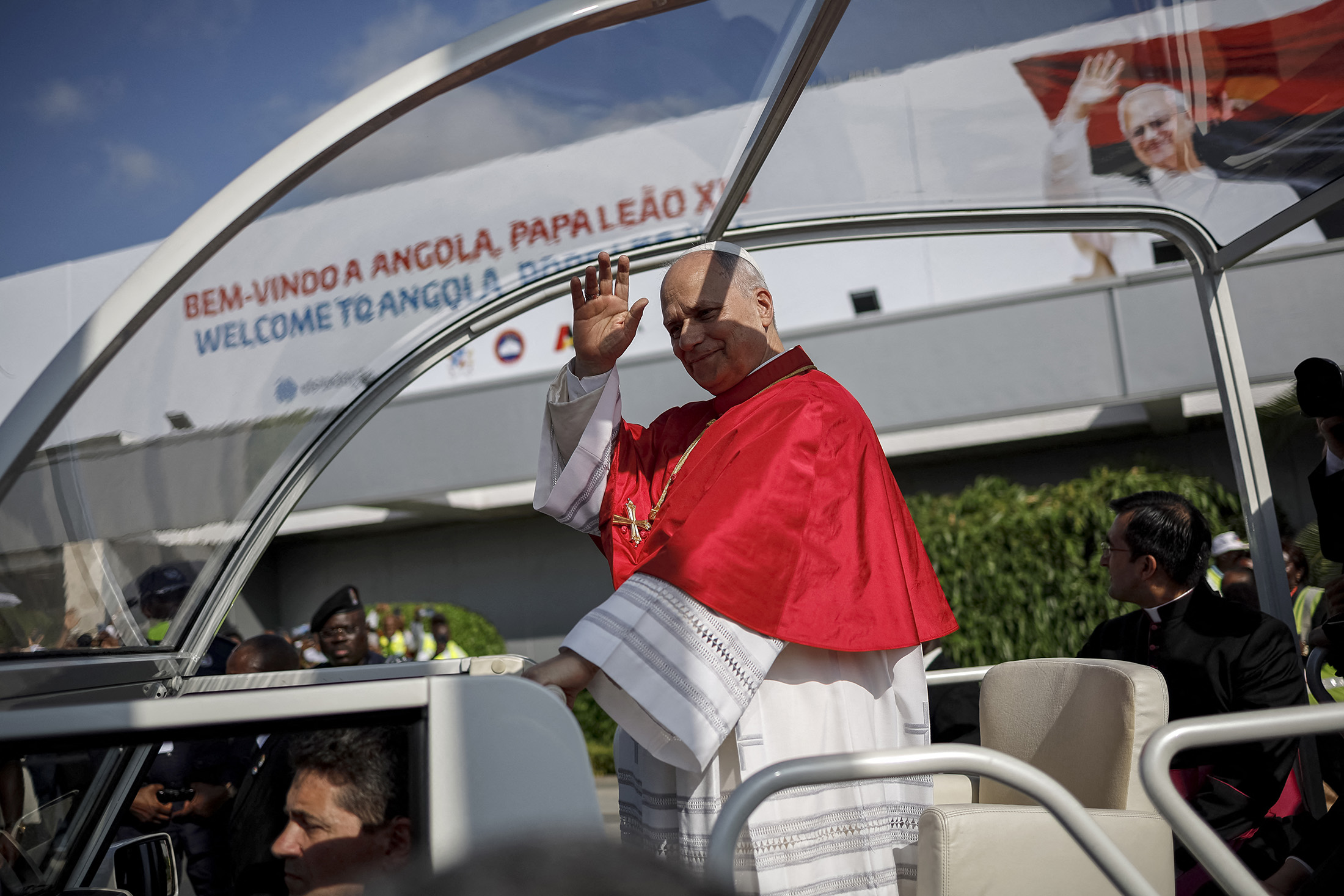 Pope Leo XIV waves from the Popemobile after arriving at the "4 de Fevereiro" Luanda International Airport in Luanda, Angola, on April 18, 2026. 