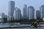 A jogger passes waterfront condominium towers in Vancouver on Aug. 13.