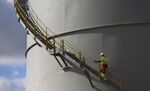 An employee climbs a staircase at a gas fired power station on the Isle of Grain, U.K.