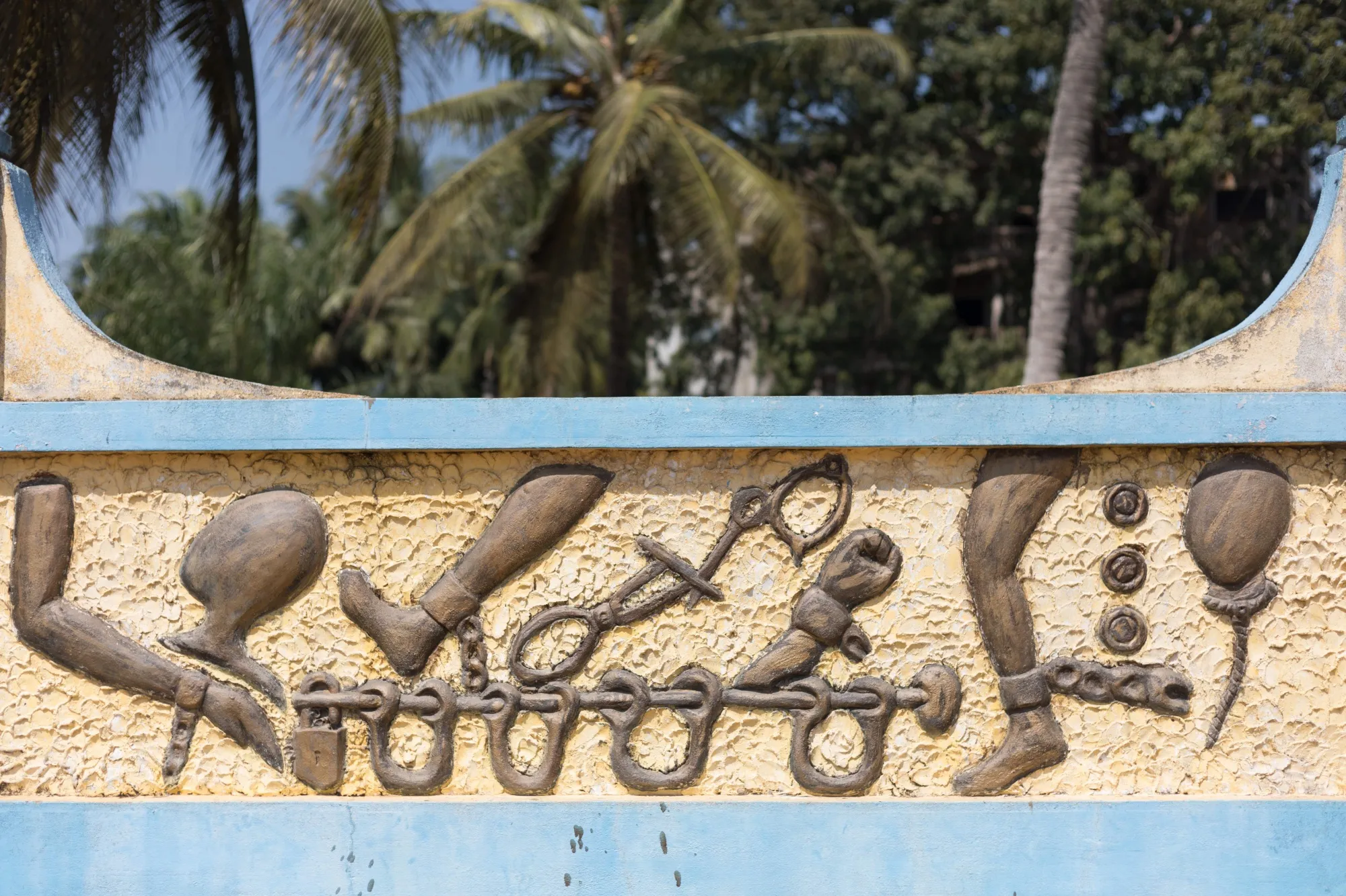 Details on a wall at the Zomachi memorial in Ouidah, Benin.