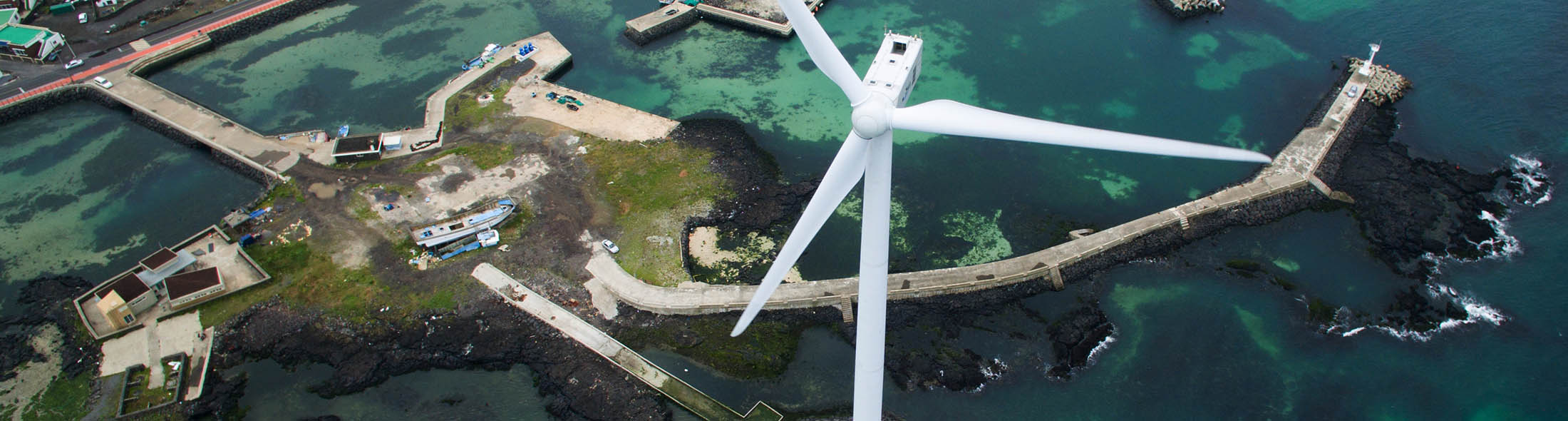 A wind turbine stands in this aerial photograph taken above the Haengwon Wind Farm in Jeju, South Korea, on Sunday, June 28, 2015. South Korea’s 15 trillion won ($13.3 billion) extra budget will channel money to the medical and tourism sectors as the Park administration seeks to cushion the impact of a deadly respiratory disease.
