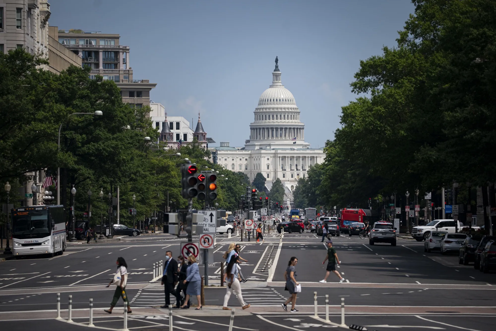 Pedestrians cross a street near the US Capitol in Washington, DC.