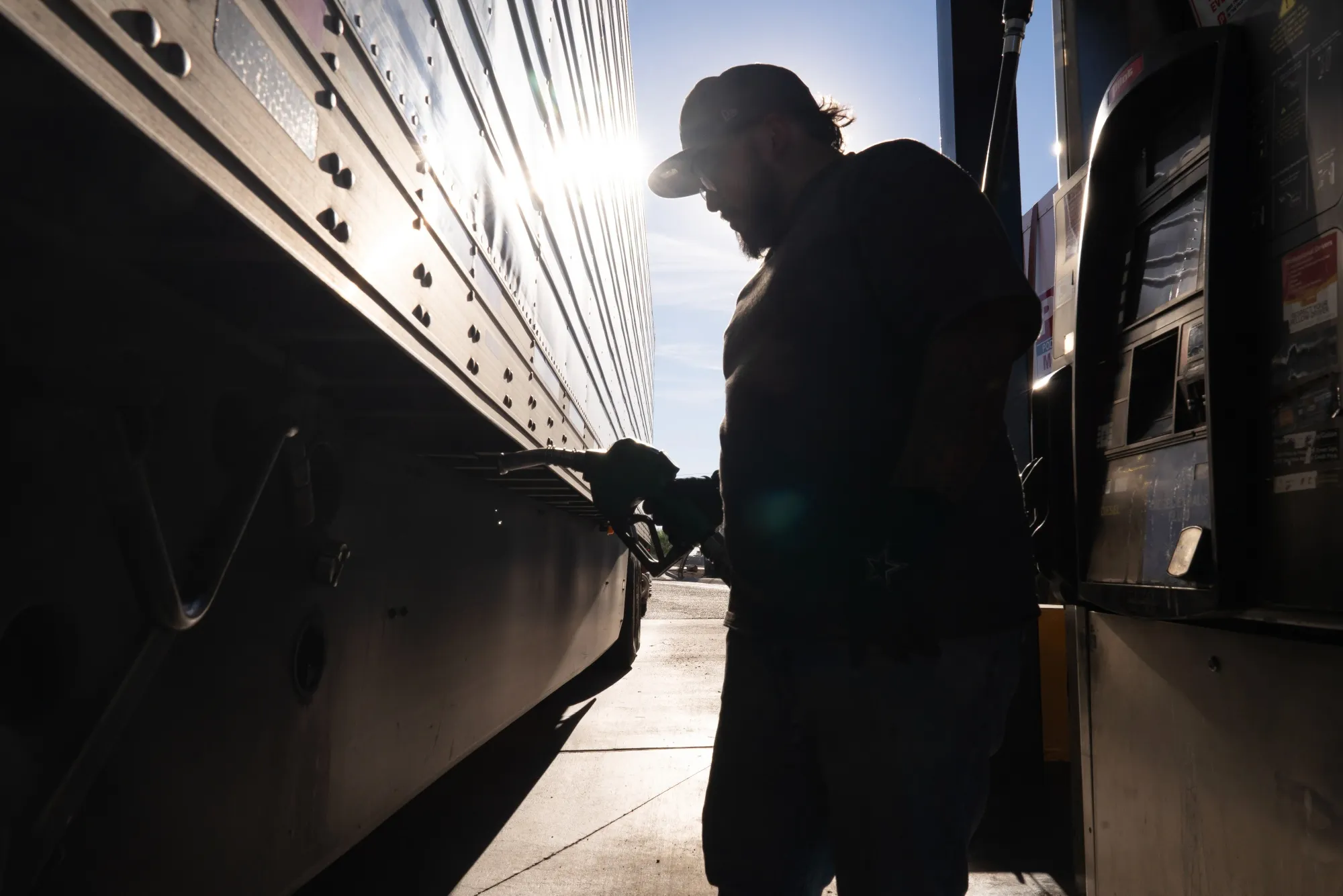 A semi truck driver refuels a truck with diesel fuel at a Pilot gas station in Eloy, Arizona, on March 18.