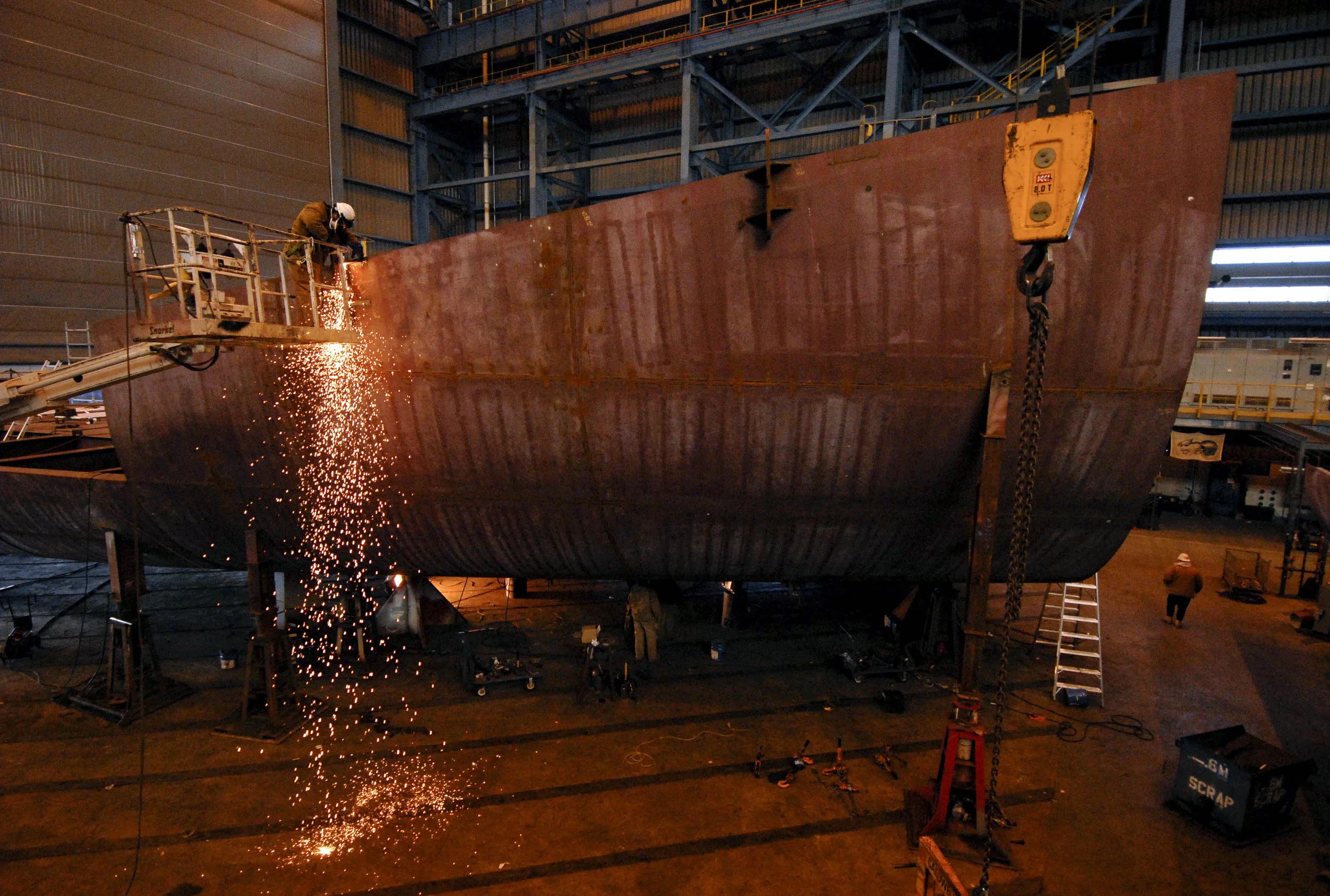A welder works on a section of a double hulled tanker being assembled at a shipyard in Philadelphia.