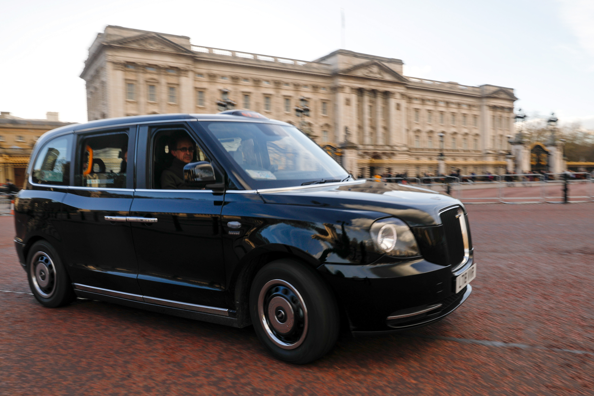 Neville Robertson, a London cabbie, drives the new&nbsp;TX City London taxi past Buckingham Palace.