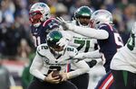 New York Jets quarterback Zach Wilson (2) is sacked by New England Patriots defensive end Deatrich Wise Jr. (91) and linebacker Josh Uche (55) during the second half of an NFL football game, Sunday, Nov. 20, 2022, in Foxborough, Mass. (AP Photo/Michael Dwyer)