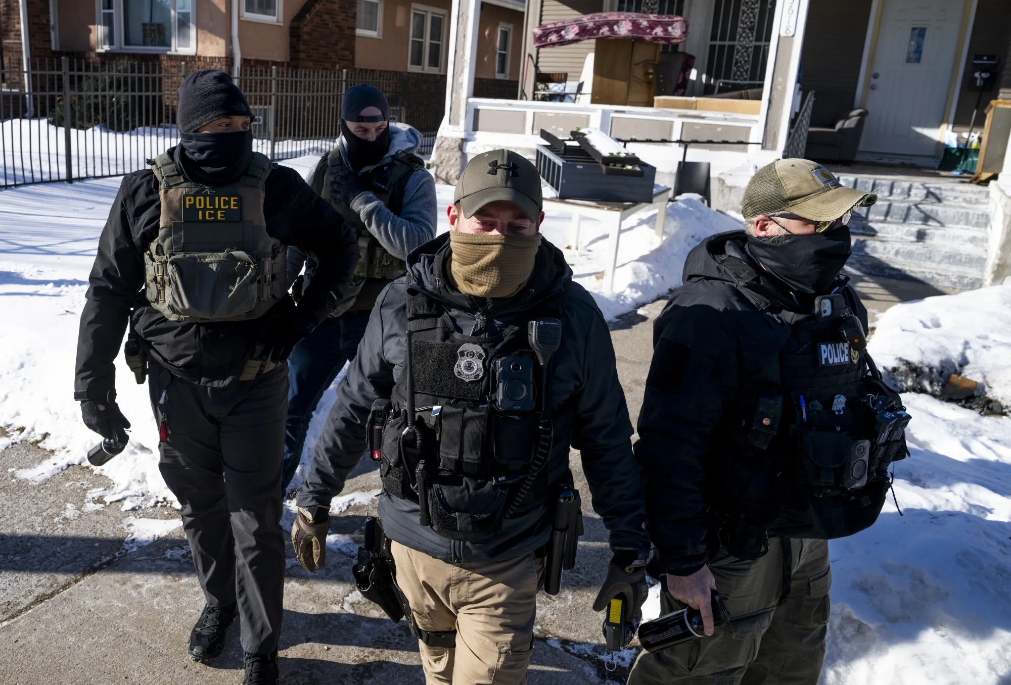 ICE agents leave a residence in Minneapolis on Jan. 28.