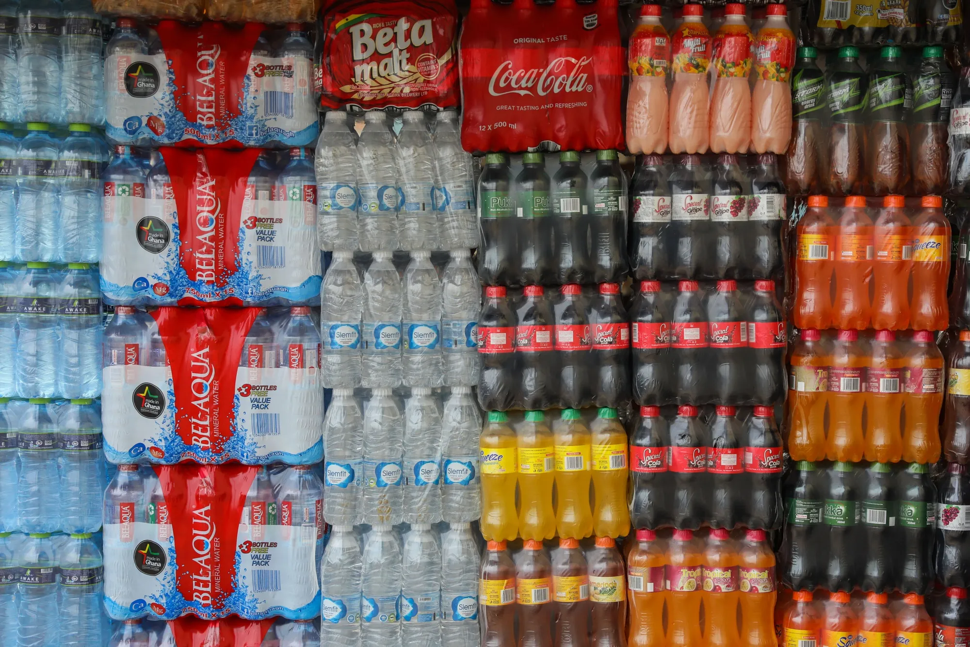 Packaged plastic bottles of water and soda for sale in Accra, Ghana.