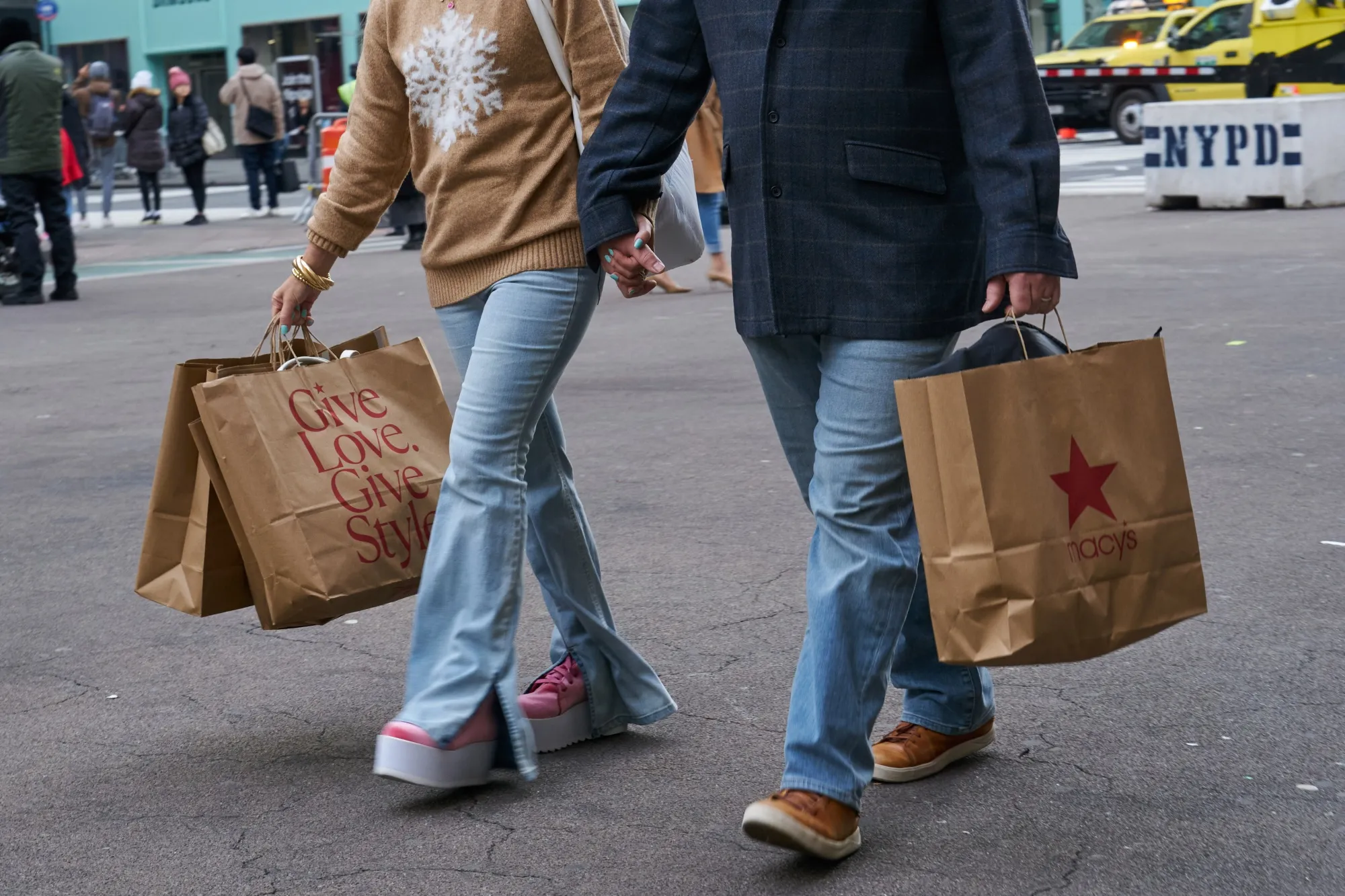 Shoppers carry Macy’s bags outside the flagship store in New York City&nbsp;on Black Friday, Nov. 24, 2023.&nbsp;