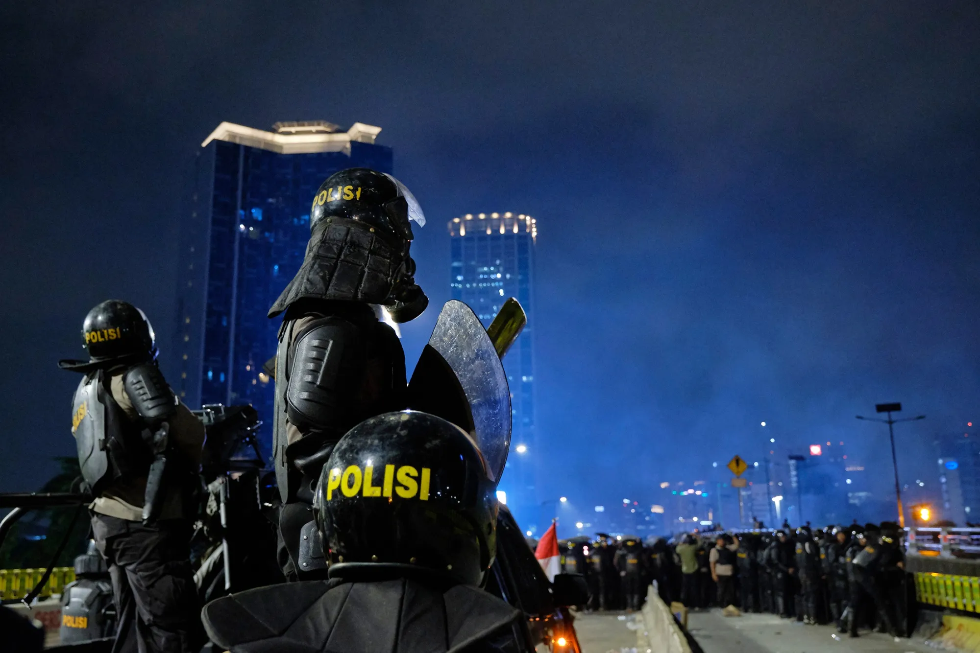 Riot police watch a blockaded road in Jakarta, on Sept. 25.
