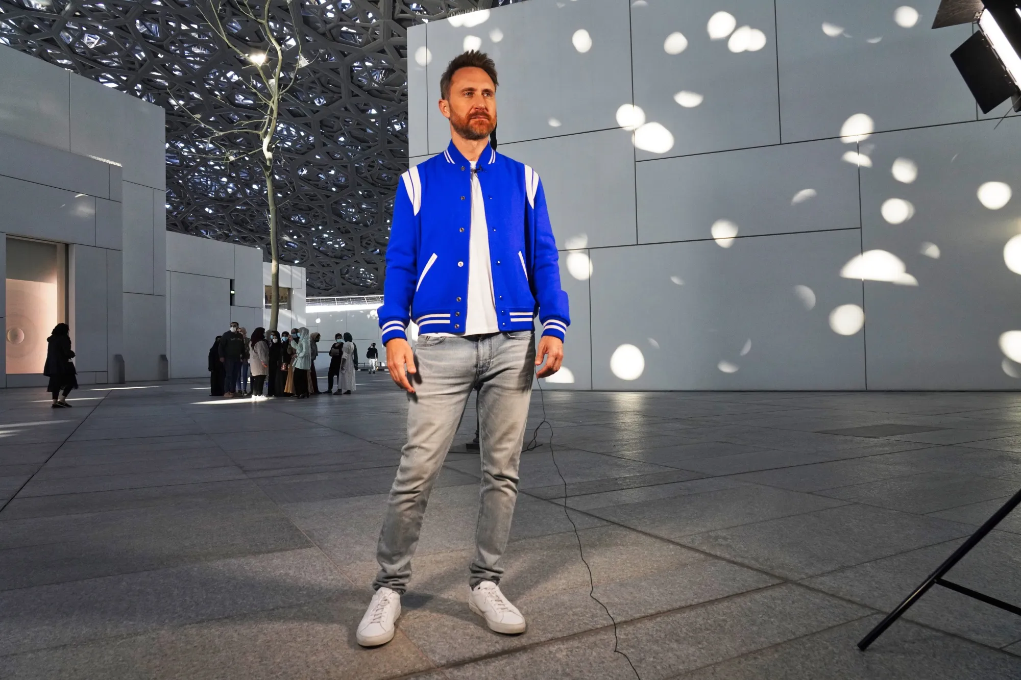 French DJ David Guetta prepares for an interview with The Associated Press at the Louvre Abu Dhabi in Abu Dhabi, United Arab Emirates, Thursday, Dec. 16, 2021. Guetta, who has a special show airing New Year's Eve that he shot at the Louvre Abu Dhabi, defended his participation in Saudi music festivals in an interview with The Associated Press amid criticism by human rights activists of performers entertaining in the kingdom. (AP Photo/Jon Gambrell)
