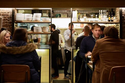 The room is casual, with communal high-top tables and stools.