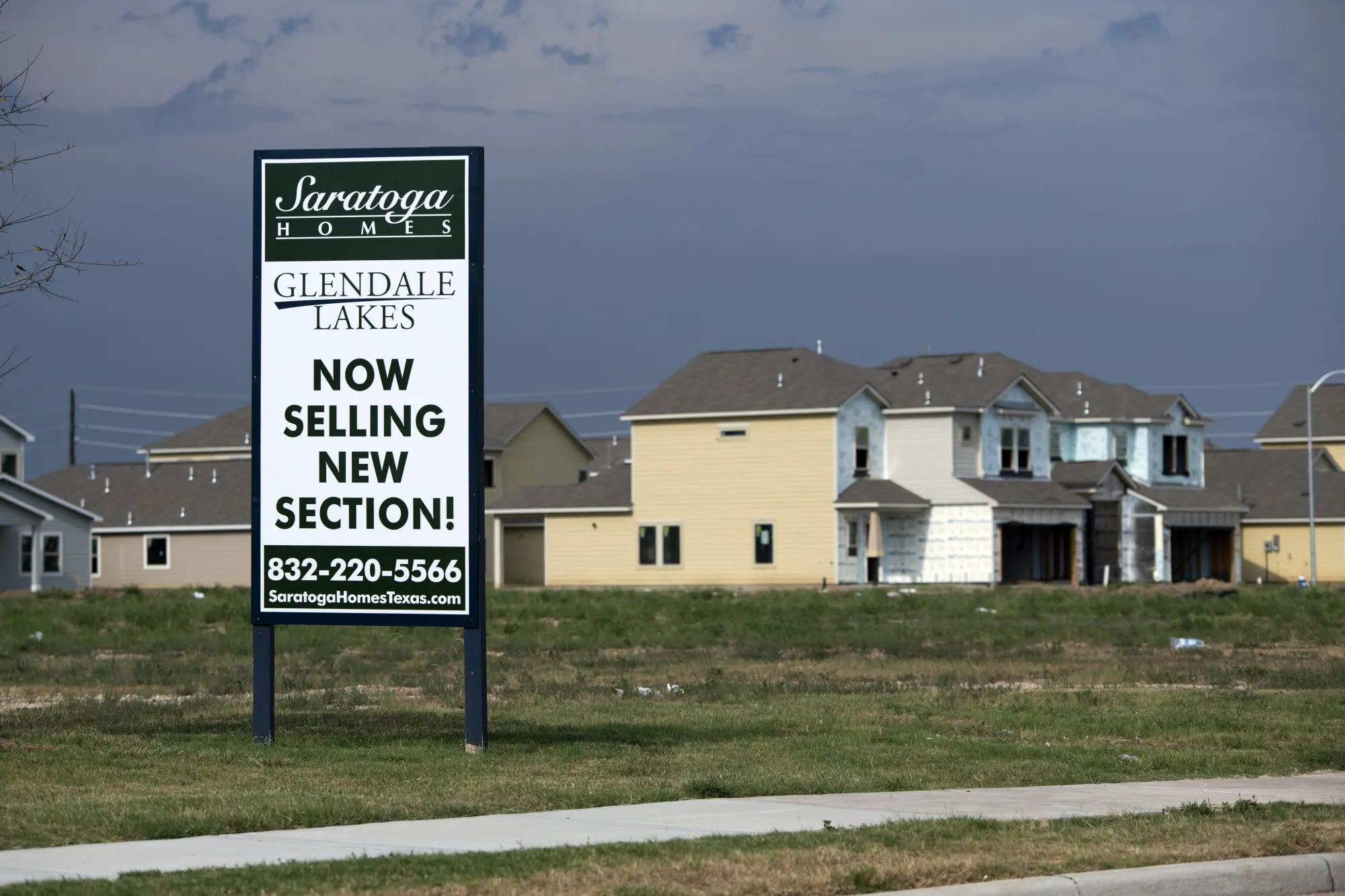 A "Now Selling" sign outside the Glendale Lakes community home development in Arcola, Texas, US.