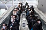 People wearing face masks ride escalators&nbsp;in Tokyo on Feb. 13.