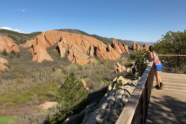 Woman trail runner Lyons Overlook Roxborough State Park red rocks Fountain Valley Trail Colorado