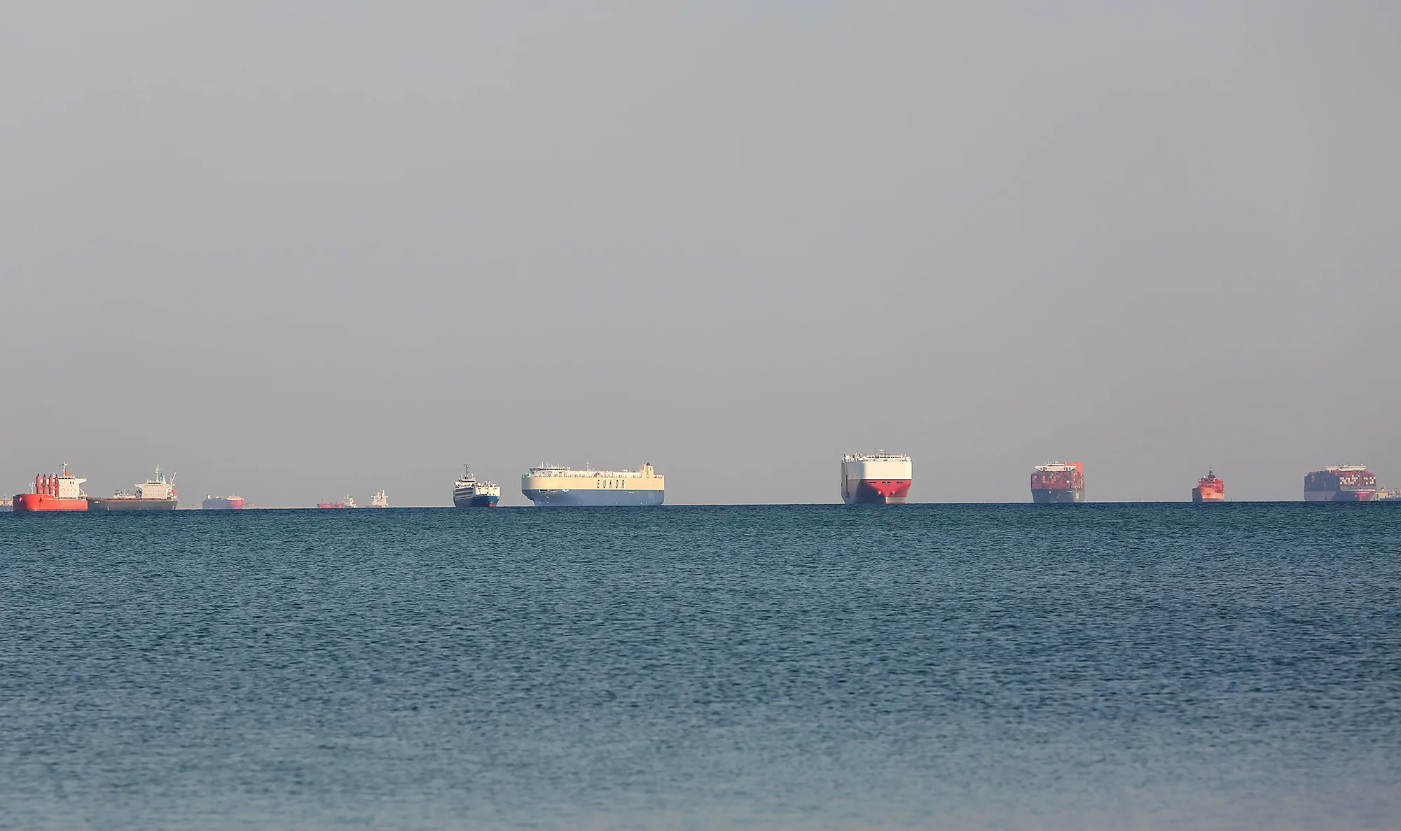 Commercial cargo and container ships ride anchor while waiting to transit the Suez Canal in Ismailia, Egypt, on March 25.