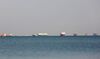 Commercial cargo and container ships ride anchor while waiting to transit the Suez Canal in Ismailia, Egypt, on March 25.