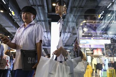 Shoppers in a mall in Bangkok.